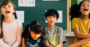 Portrait of school children smiling in classroom