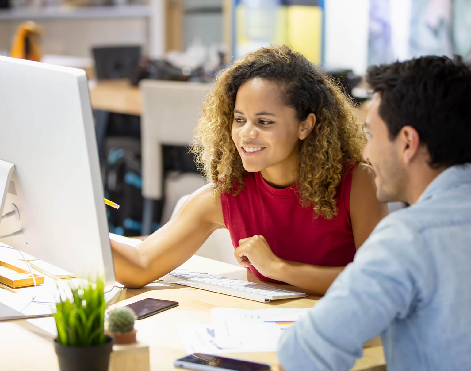 Coworkers looking at a computer