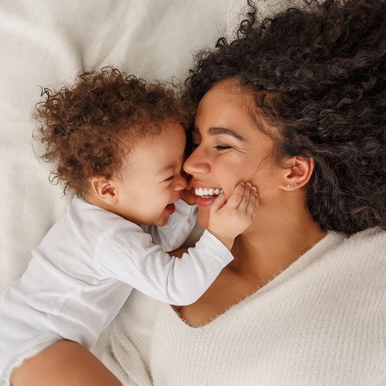 Parent and baby lying together