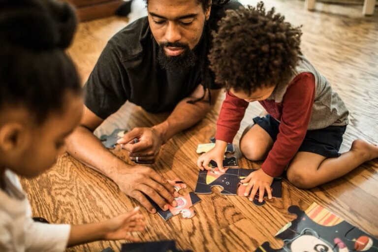 parent working on a puzzle with kids