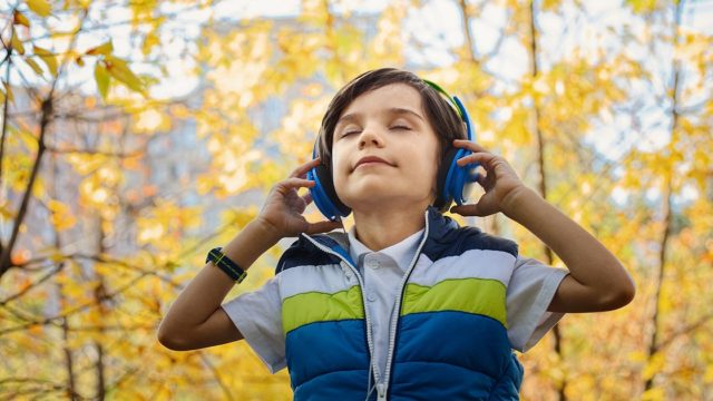 child listening to a podcast
