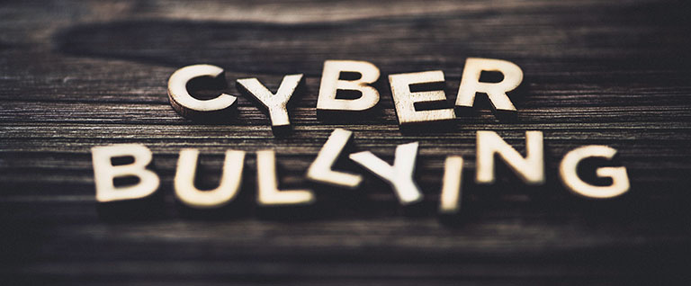 cyber bullying spelled in wood blocks