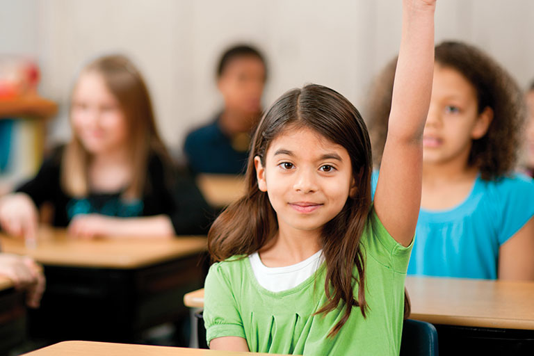 girl raising hand in class