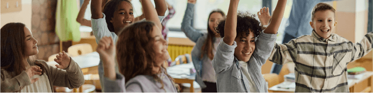 Children cheering in a classroom.